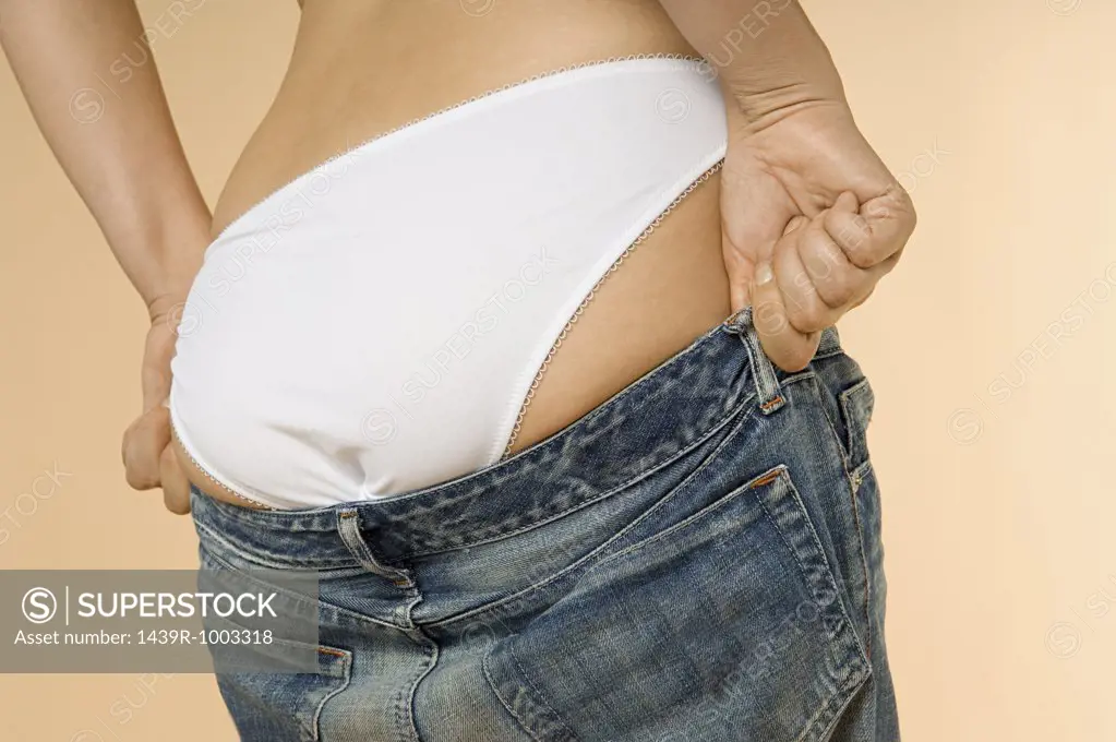 Woman putting on jeans