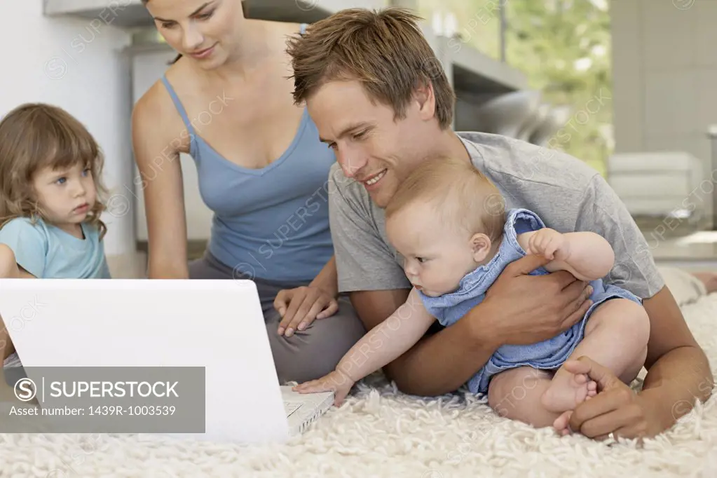 Family using a laptop computer