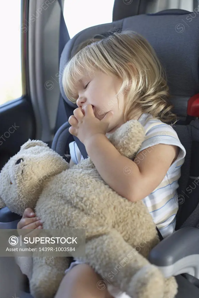 Young girl sleeping in a car