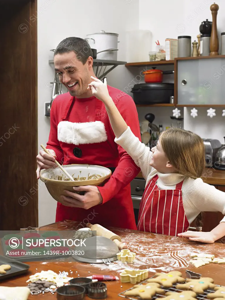Father and daughter making cookies