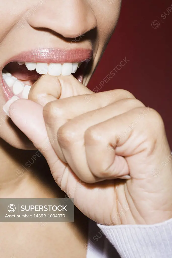 Woman biting her knuckle