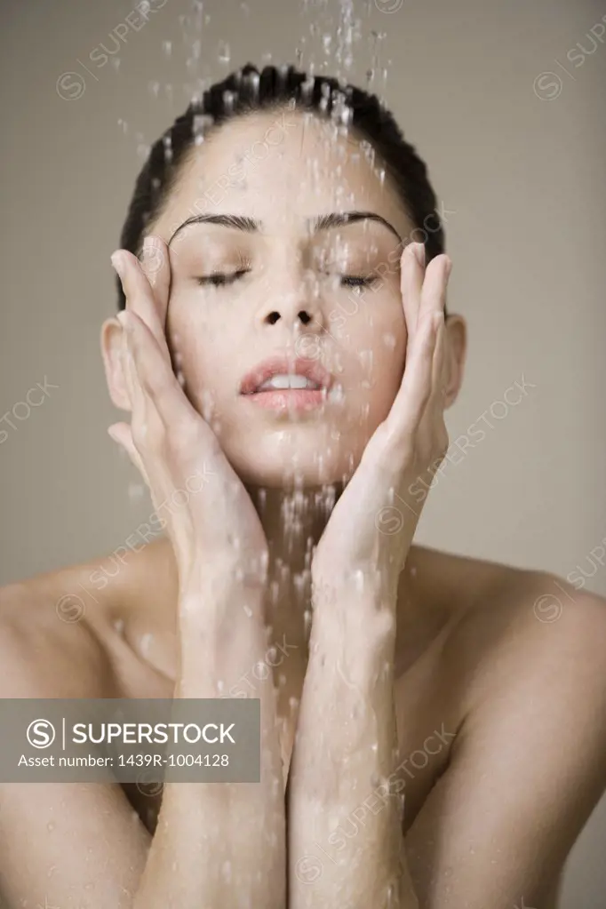 Woman under shower of water