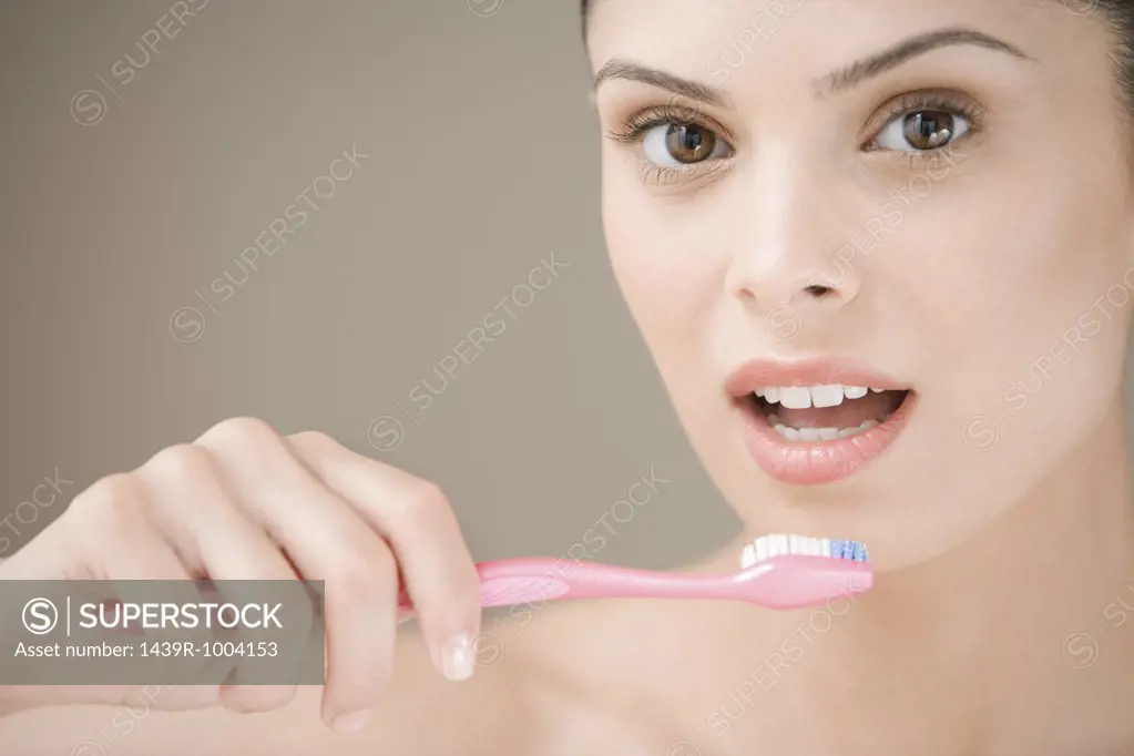 Young woman holding a toothbrush