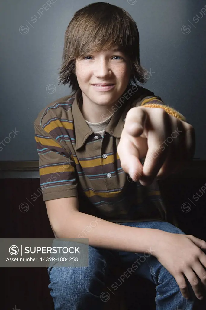 Teenage boy pointing at camera