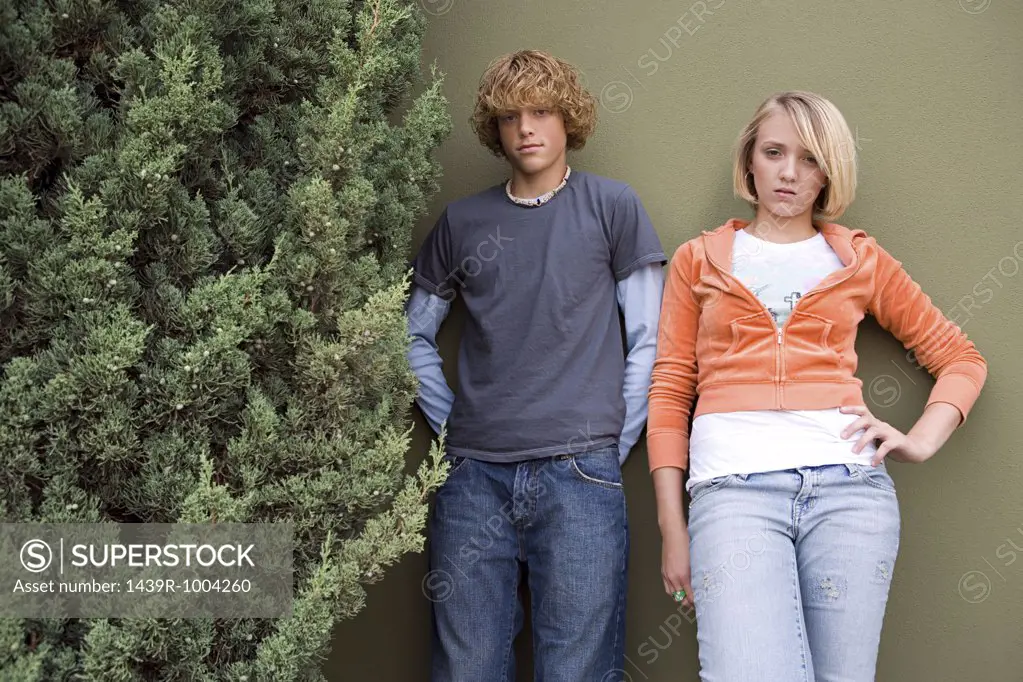 Teenage couple stood outdoors