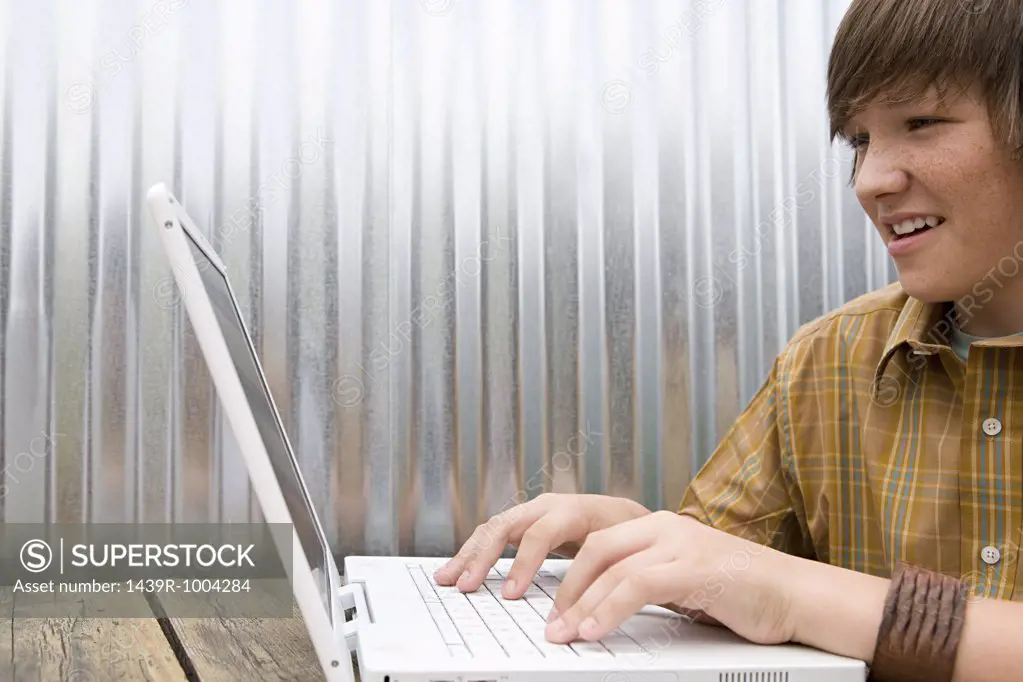 Teenage boy working on laptop