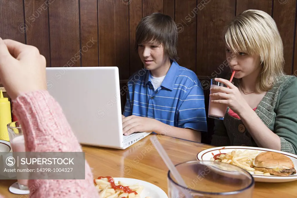 Three teenagers at a cafe