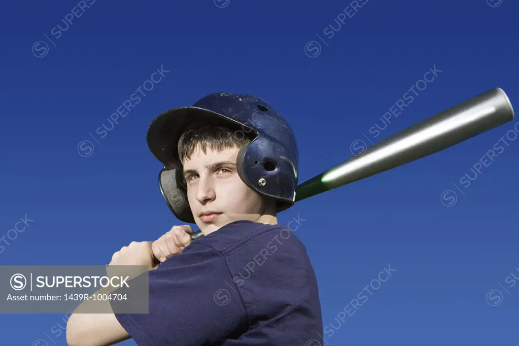 Teenage boy about to swing baseball bat
