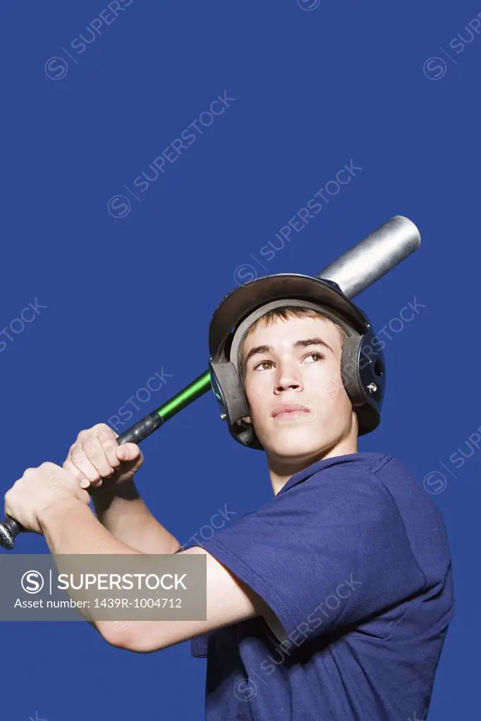 Teenage boy about to swing baseball bat