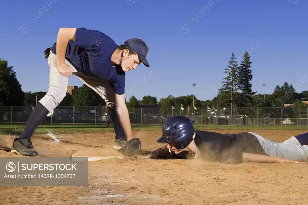 Two teenage boys playing baseball