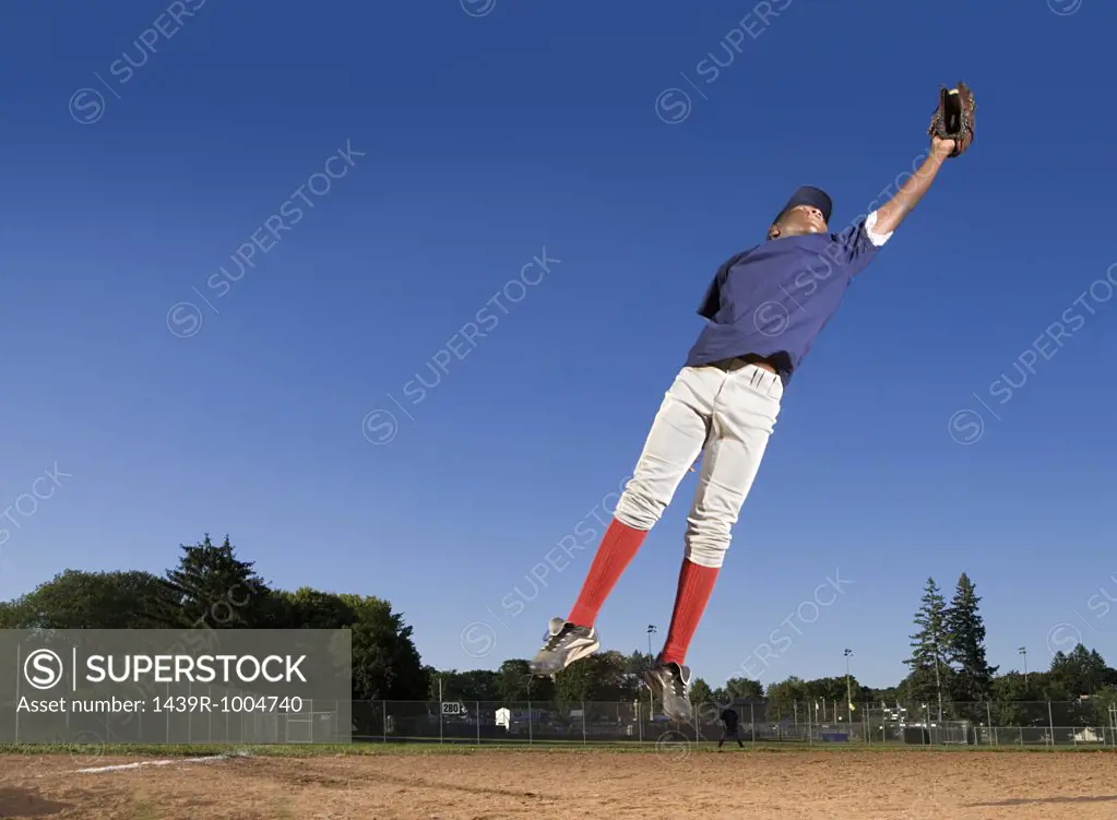 Teenage boy playing baseball