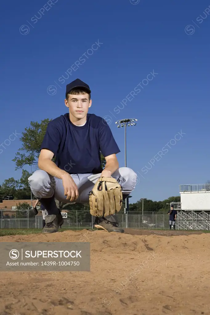 Teenage boy playing baseball