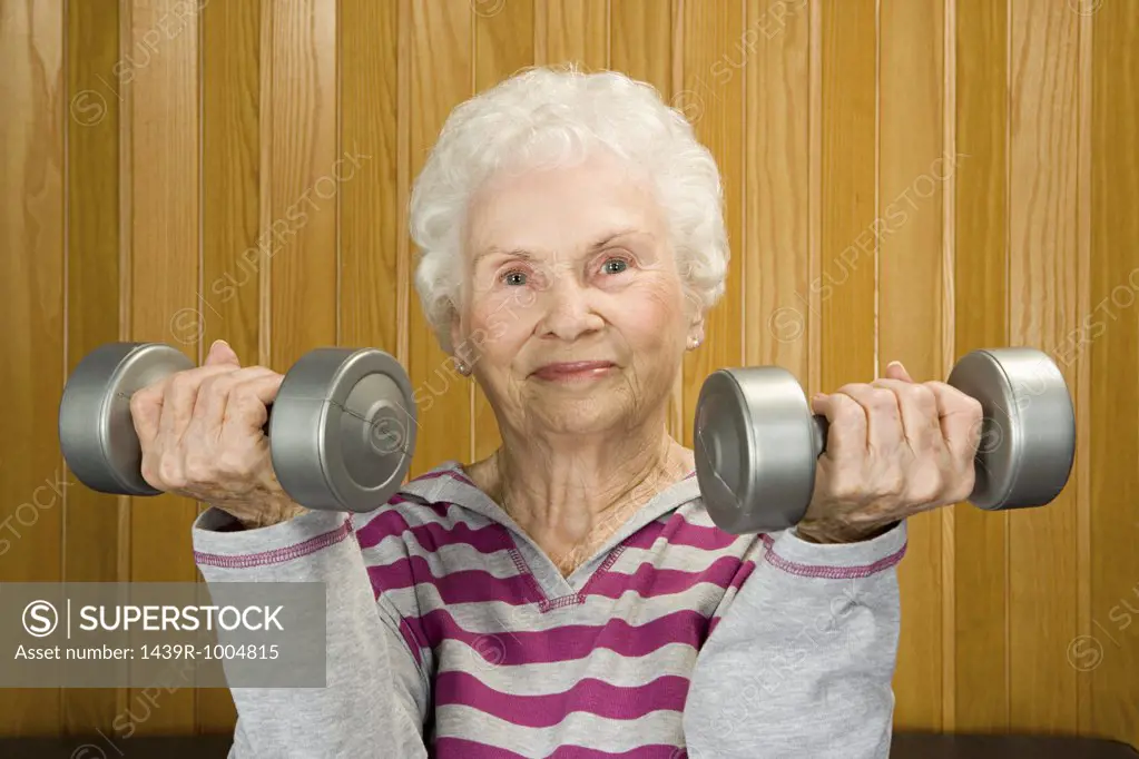 Senior woman lifting dumbbells