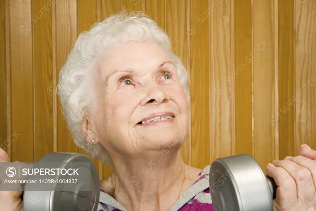 Senior woman lifting dumbbells