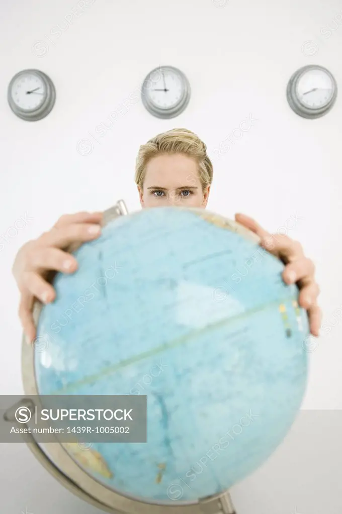 Businesswoman holding a globe