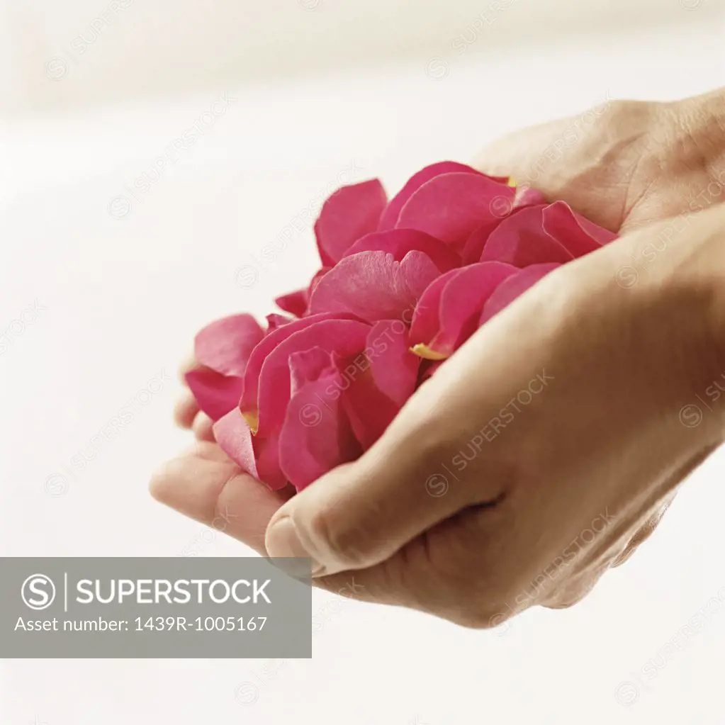 Woman holding rose petals