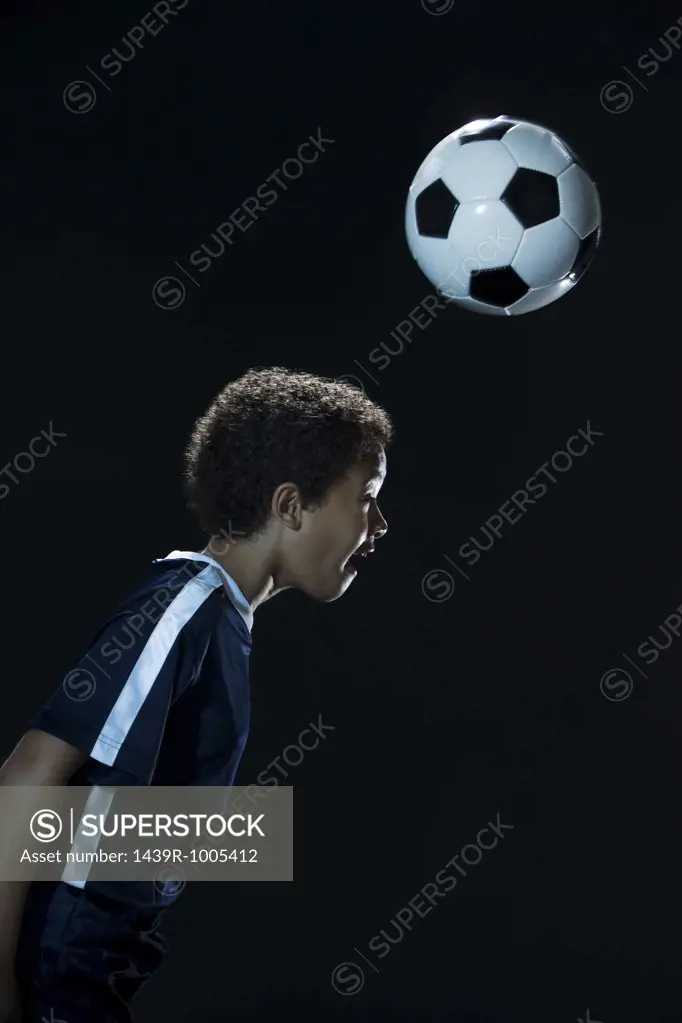 Boy heading a football