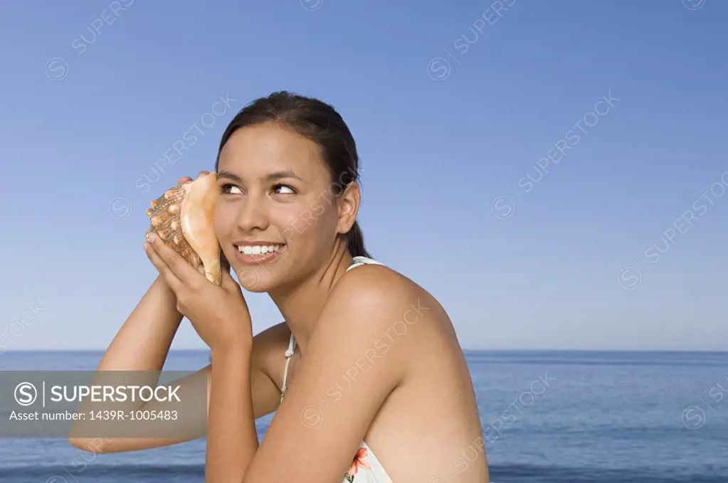 Young woman with conch shell