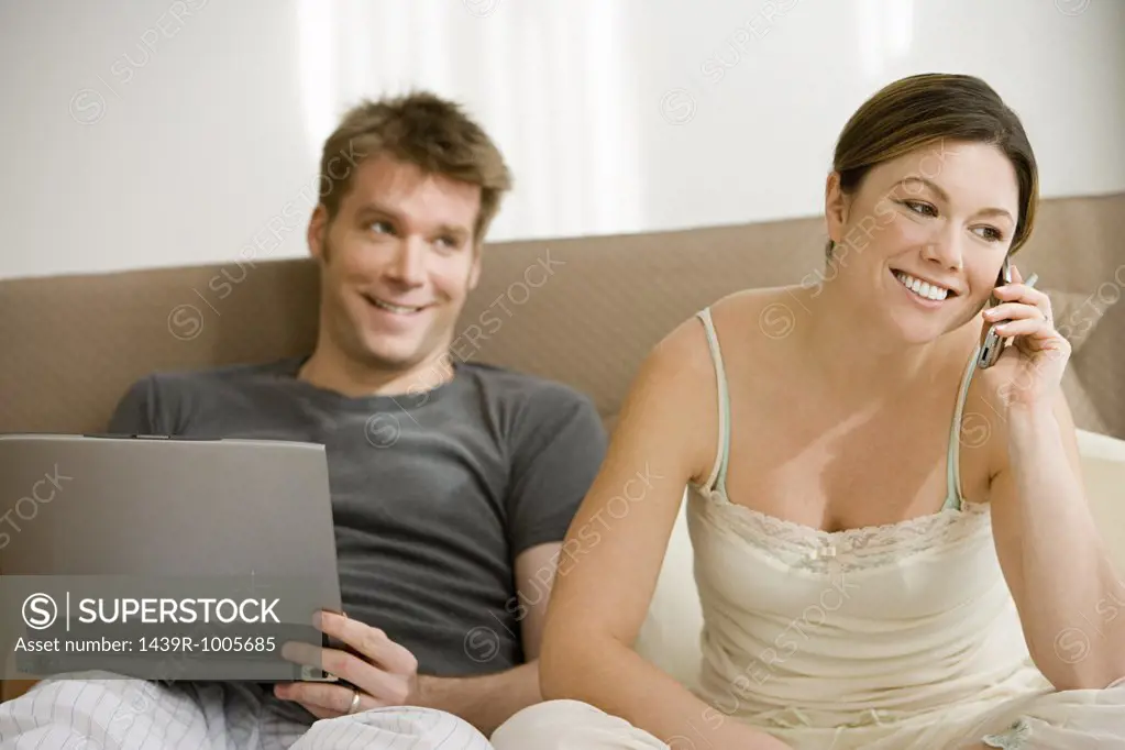 Couple with cellphone and laptop
