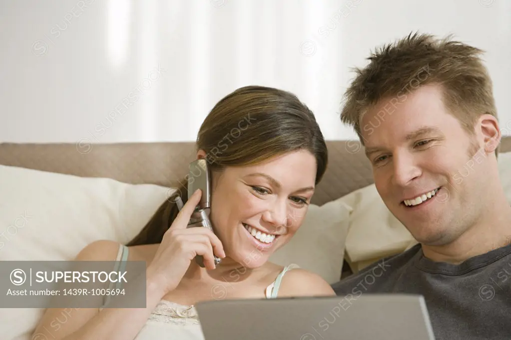 Couple with cellphone and laptop