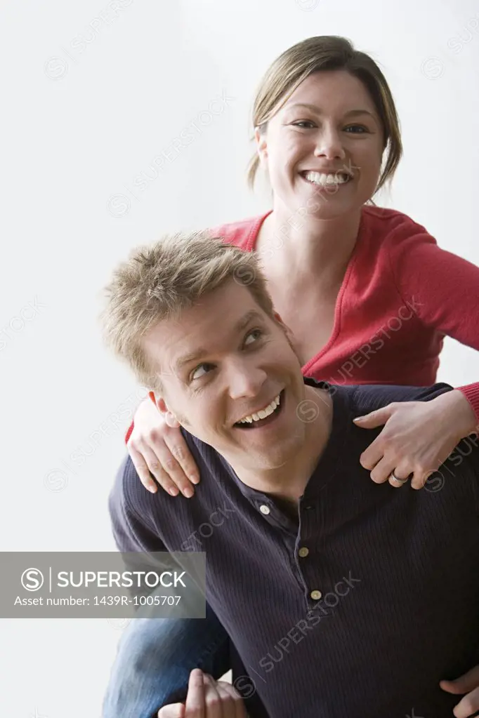 Man giving woman piggyback