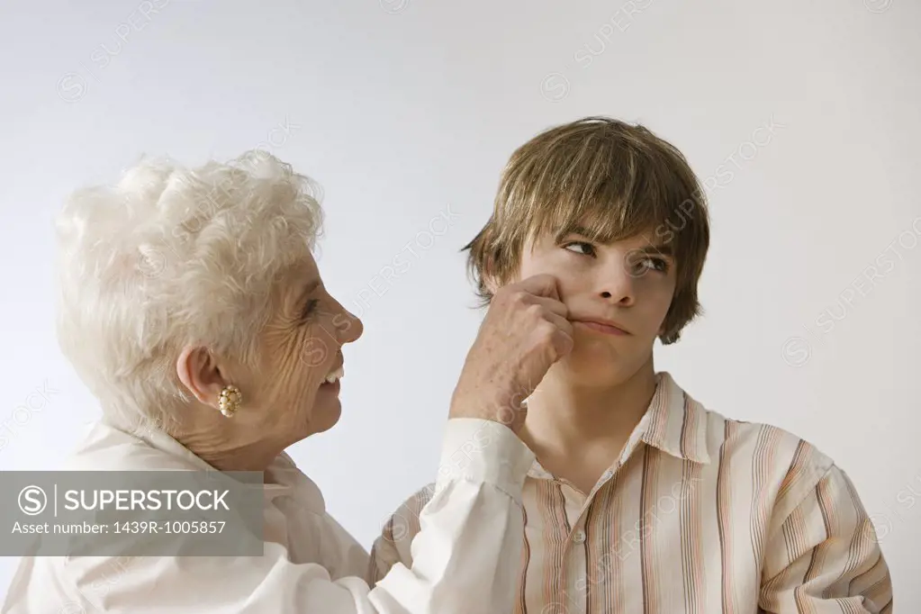 Woman grabbing grandson's cheek