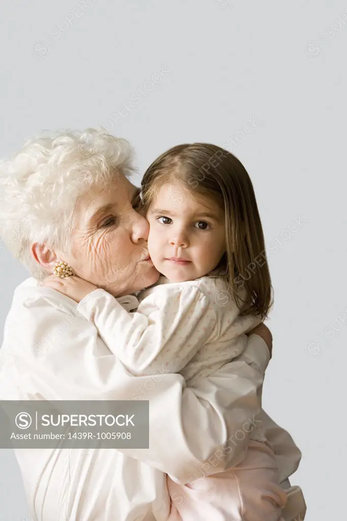 Grandmother kissing granddaughter