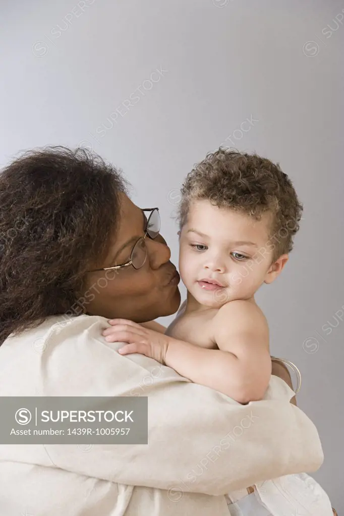 Grandmother cuddling baby boy