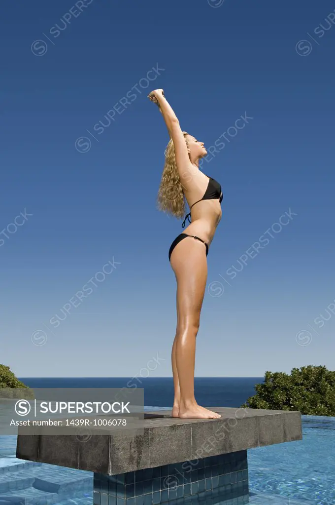 Woman standing on platform in pool