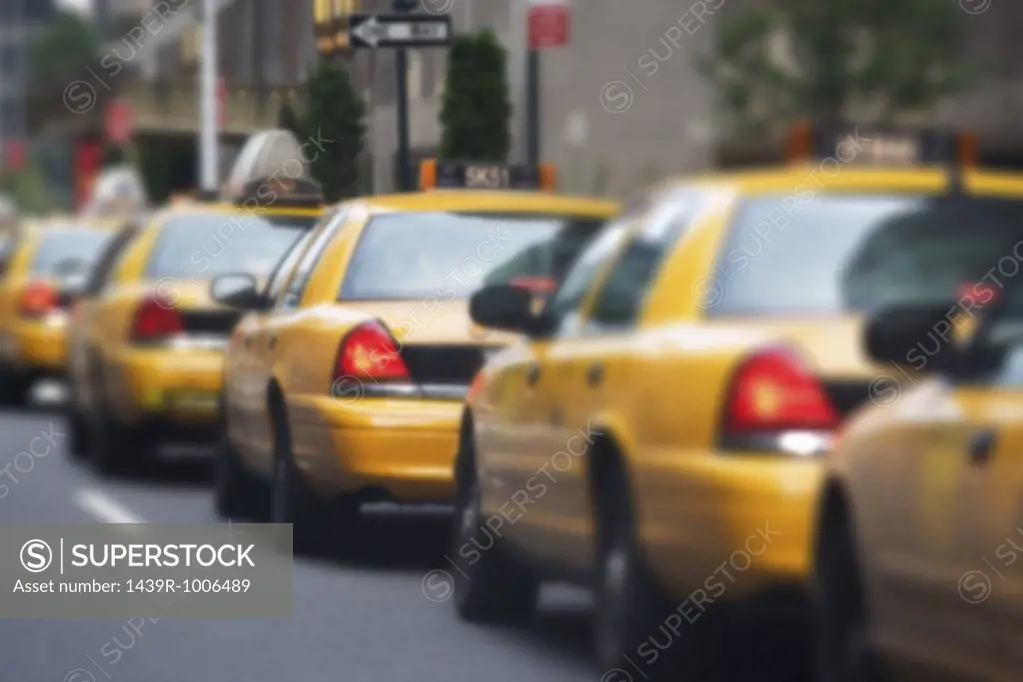 Queue of yellow taxi cabs
