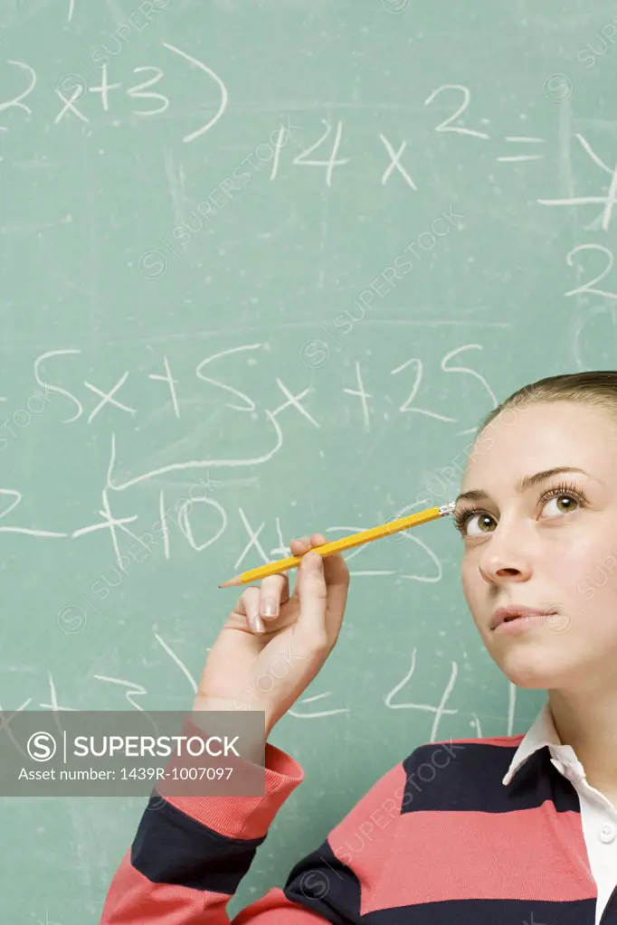 Female student trying to solve formula