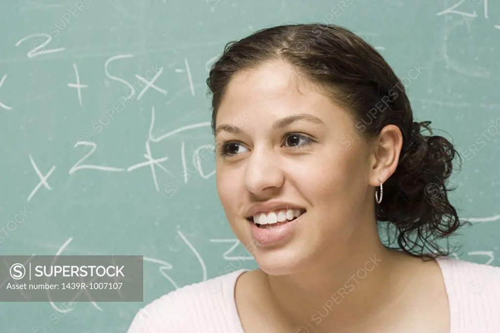 Female student in front of blackboard