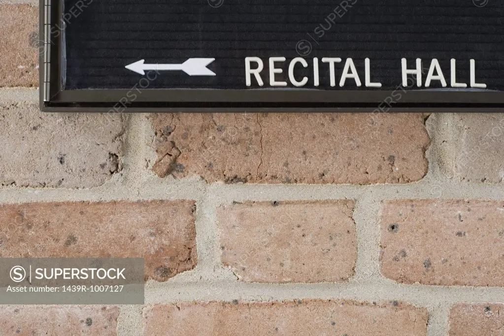 Recital hall sign on brick wall