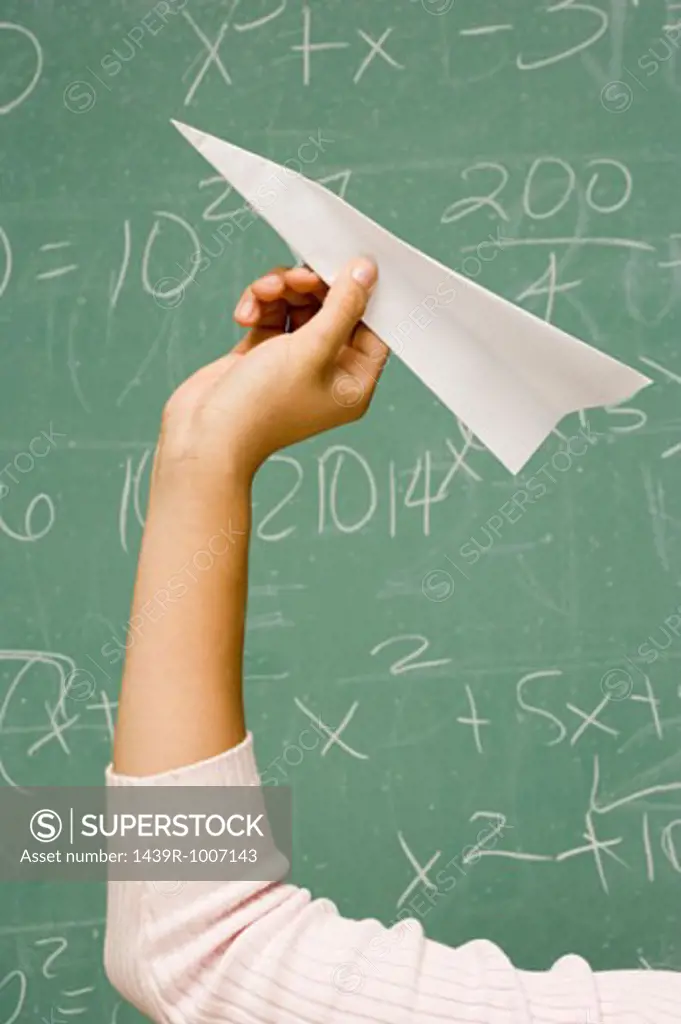 Student about to throw a paper aeroplane
