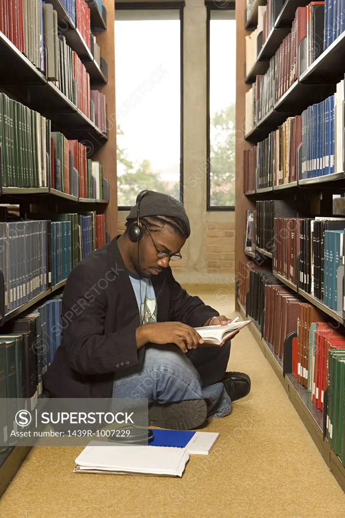 Male student reading in the library