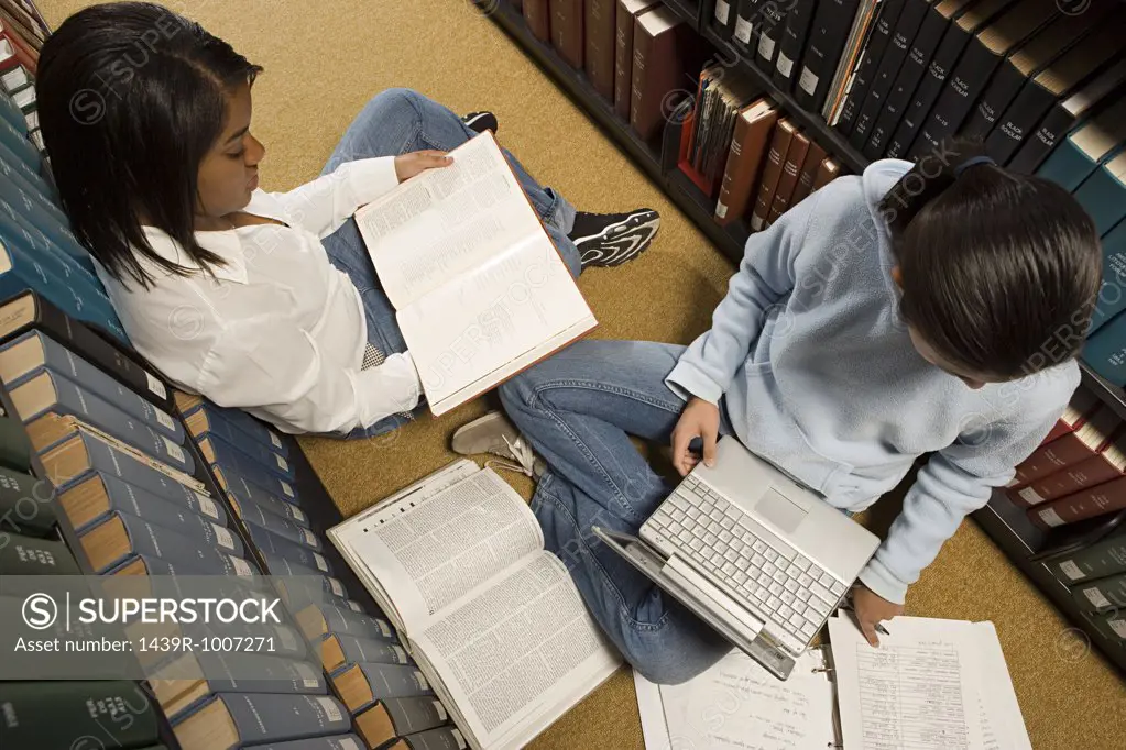 Two female students studying in the library