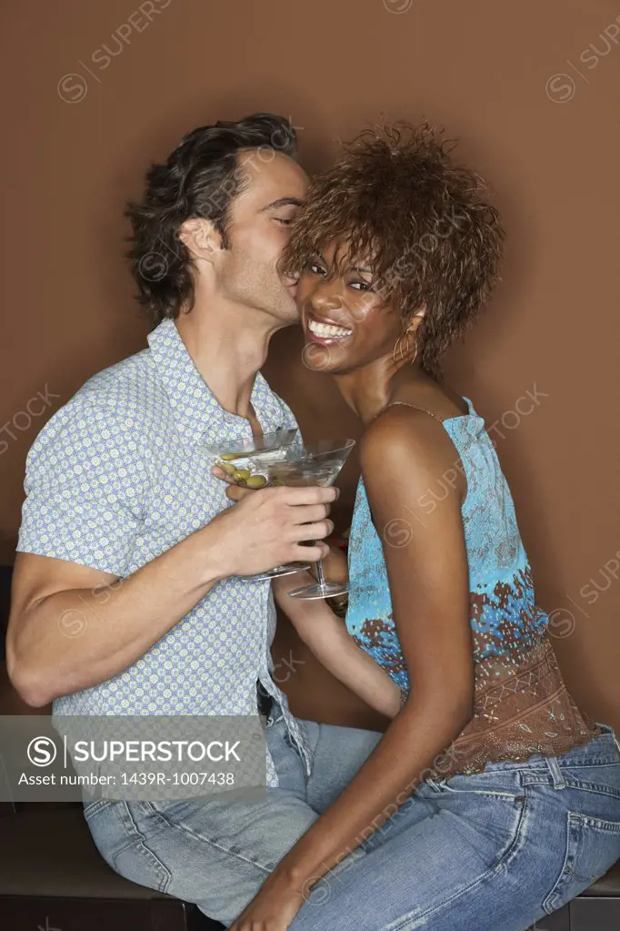 Flirtatious couple with cocktails