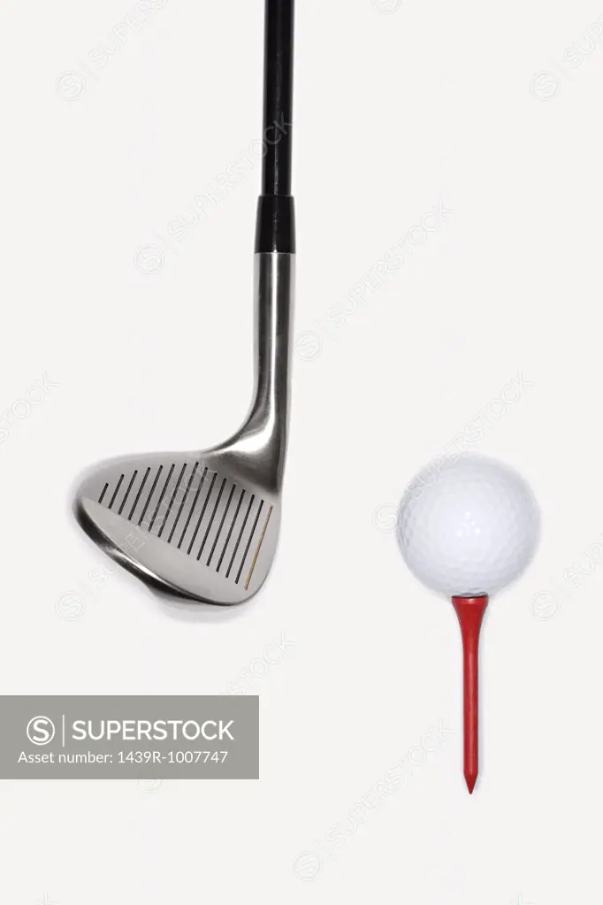 Golf club with golf ball on a tee