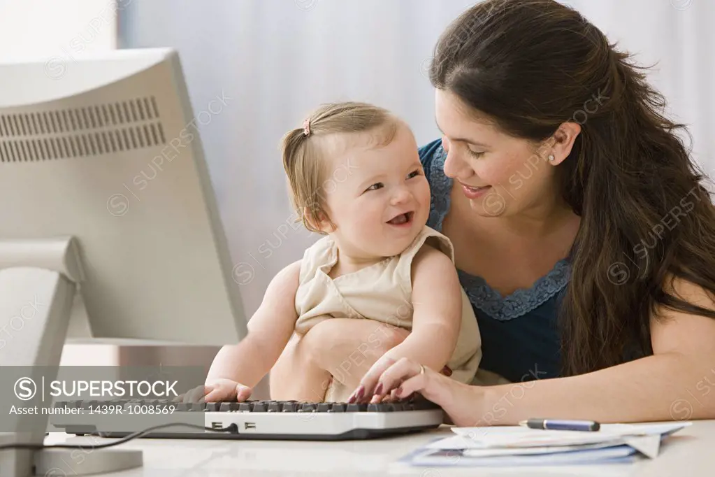 Mother and daughter using computer