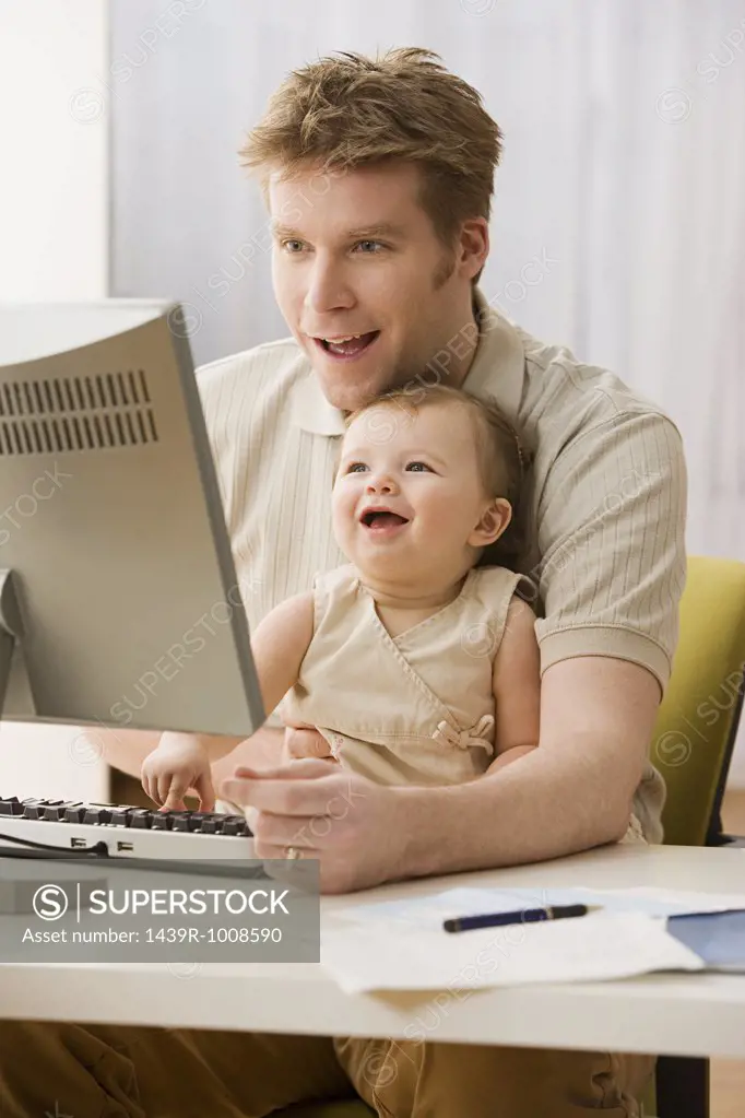 Father and daughter using computer