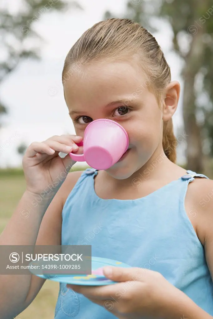 Girl drinking from a plastic cup