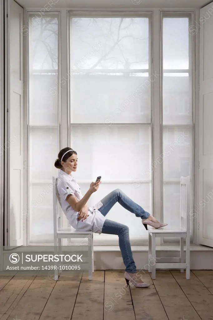 Woman on chairs with handheld computer