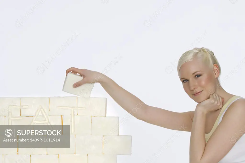 Young woman holding a block of lard