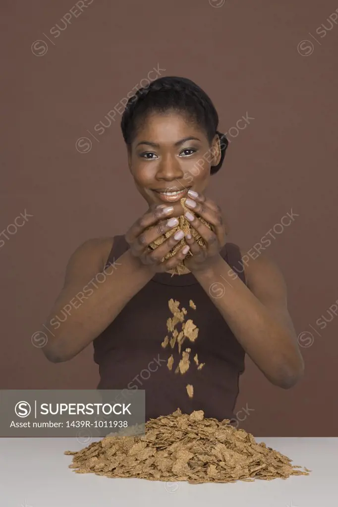 Young woman dropping cereal