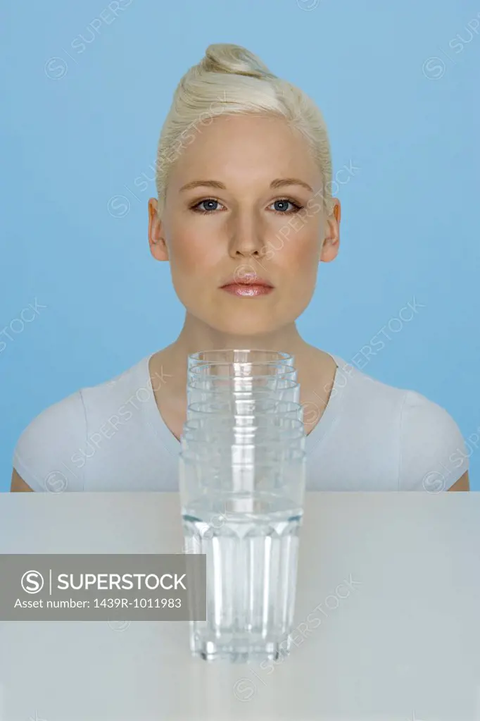 Young woman with glasses of water