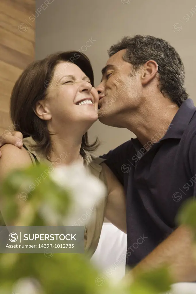 Husband kissing wife