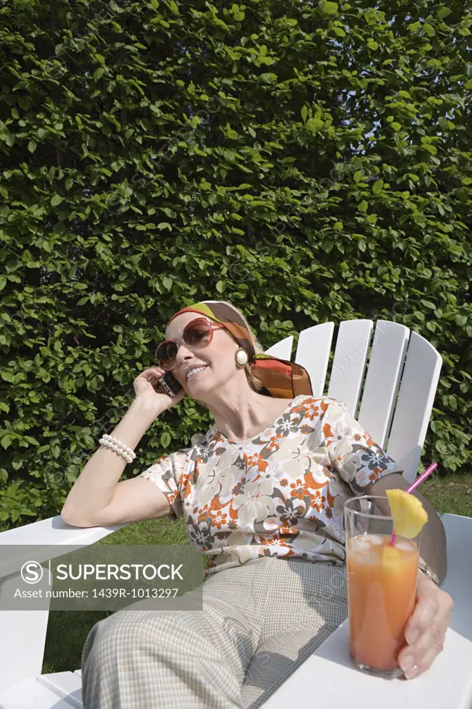 Senior woman on cellphone in garden