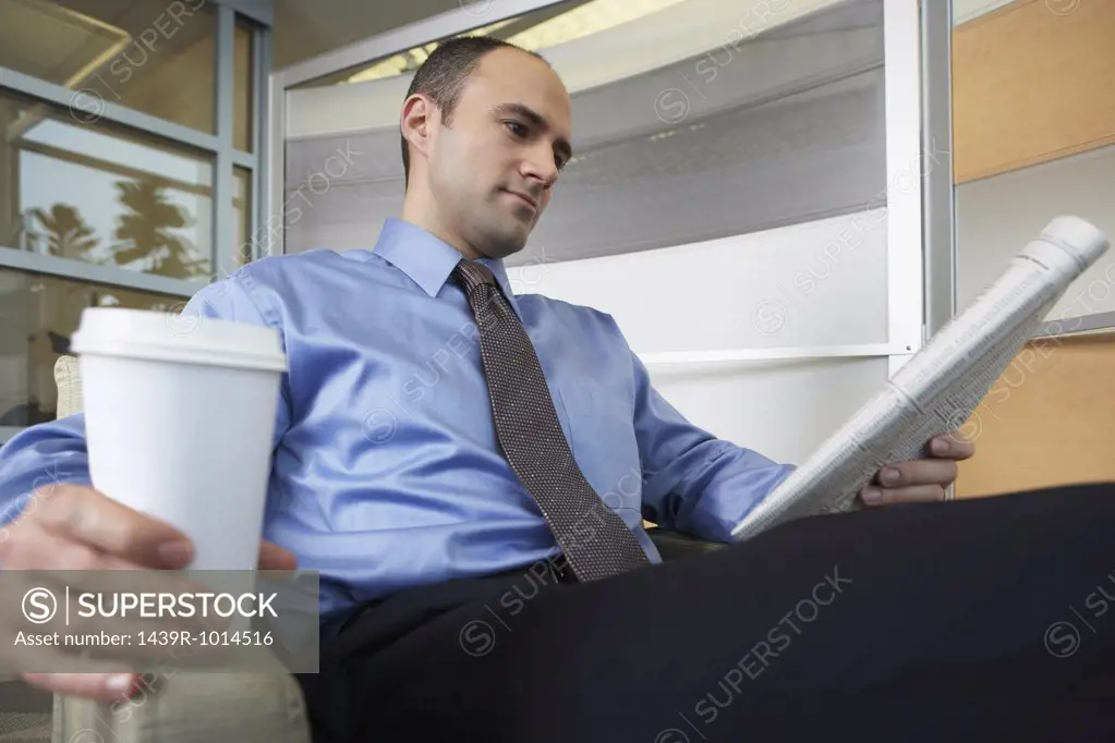 Man reading a broadsheet newspaper