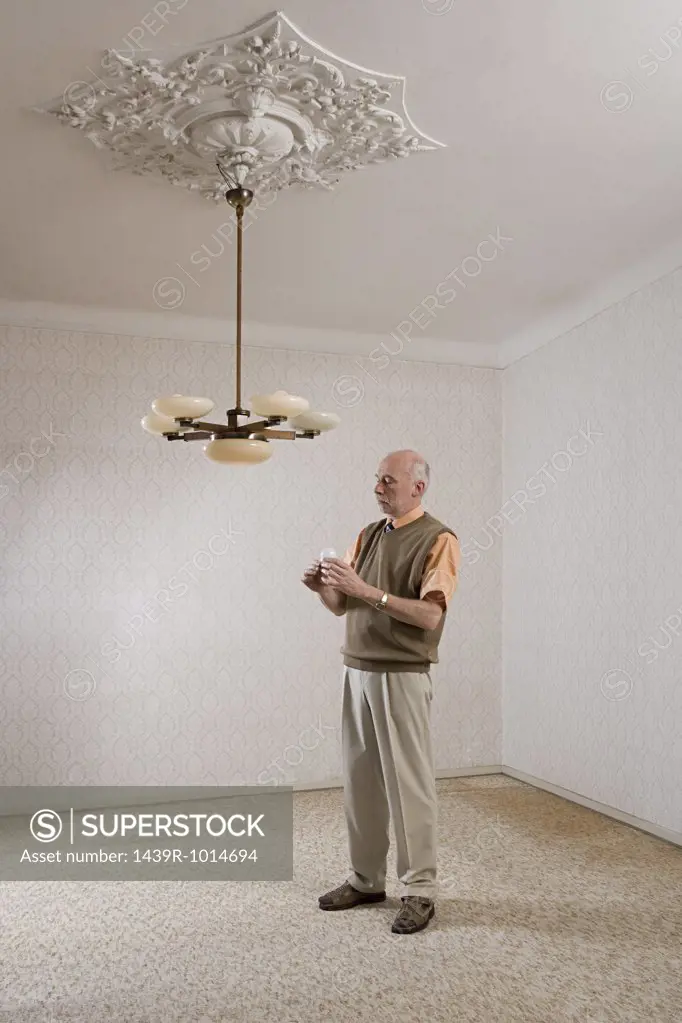 Man about to change a lightbulb