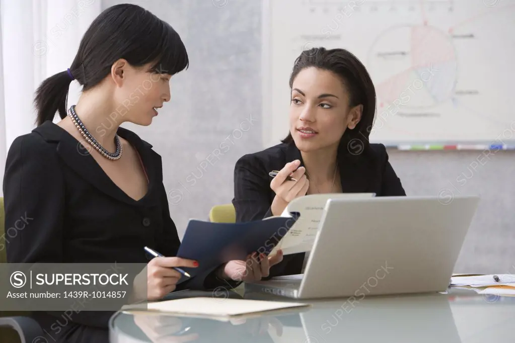 Two young women working with laptop